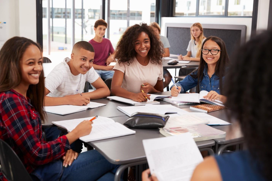 A group of students sitting at a table

Description automatically generated